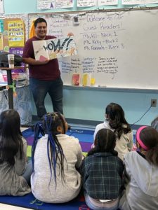cesar reading to class