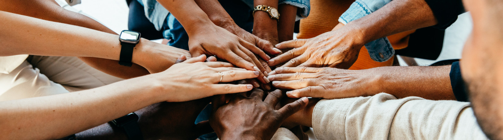 multicultural hands coming together