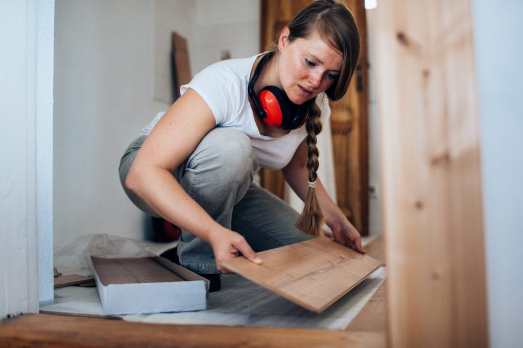 woman installing flooring