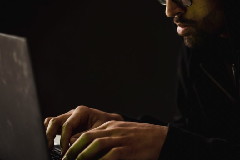 man typing on computer