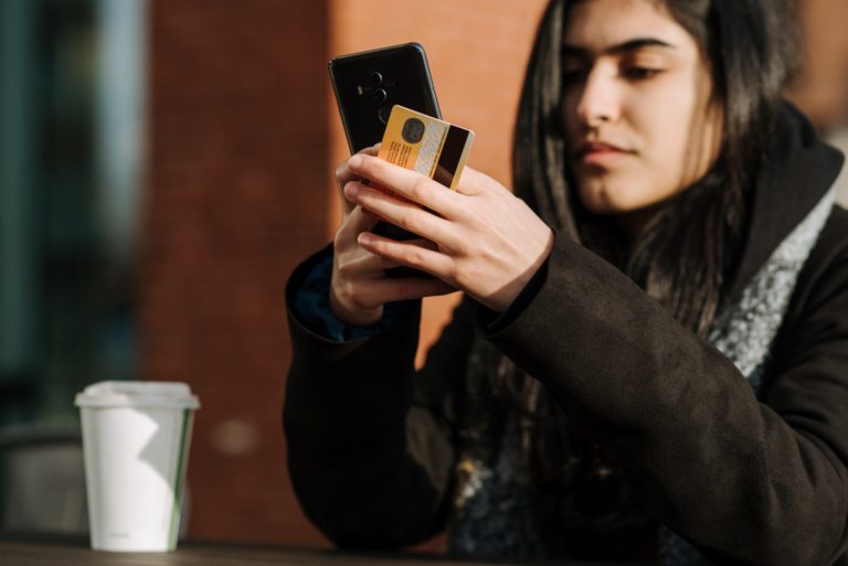 woman with credit card and cellphone