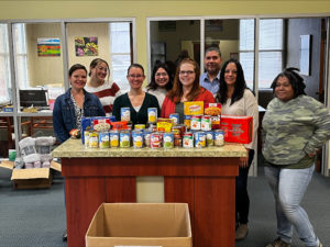 staff with food drive donations